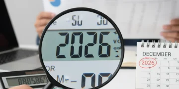 Calculator showing 2026, coins, and calendar representing Social Security benefit adjustments.